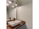 Modern bathroom with dark wood vanity, unique sink, brushed-metal faucet, and stylish lighting at 5345 Pilgrim Point Rd, Cumming, GA 30041