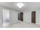 Spacious bedroom featuring neutral paint, luxury vinyl plank flooring, and multiple closets and bathroom access at 5345 Pilgrim Point Rd, Cumming, GA 30041