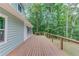 Rear view of the deck, overlooking lush trees, with access to the yard at 5345 Pilgrim Point Rd, Cumming, GA 30041
