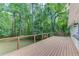 Spacious deck with cable railings offers a peaceful outdoor living space surrounded by lush greenery at 5345 Pilgrim Point Rd, Cumming, GA 30041
