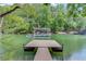 Beautiful lake view featuring a private dock with boat lift and serene water at 5345 Pilgrim Point Rd, Cumming, GA 30041