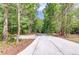 Long, paved driveway leading through a wooded area to the property at 5345 Pilgrim Point Rd, Cumming, GA 30041