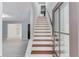 Welcoming foyer with hardwood stairs, light gray walls, and glass paneled front door at 5345 Pilgrim Point Rd, Cumming, GA 30041