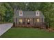 Charming home featuring a covered front porch,dormers, and inviting curb appeal at 5345 Pilgrim Point Rd, Cumming, GA 30041