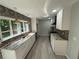 Modern kitchen with granite countertops, stainless steel appliances and beautiful backsplash at 5345 Pilgrim Point Rd, Cumming, GA 30041