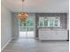 Open kitchen with white cabinets, modern backsplash, and a view of the outdoor deck at 5345 Pilgrim Point Rd, Cumming, GA 30041
