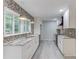Bright kitchen with granite countertops, patterned backsplash, stainless appliances, and large window at 5345 Pilgrim Point Rd, Cumming, GA 30041