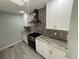 The kitchen area includes granite countertops, stainless steel appliances, and elegant backsplash at 5345 Pilgrim Point Rd, Cumming, GA 30041