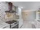 Modern kitchen with stainless steel appliances, range hood, decorative backsplash, and view to dining area at 5345 Pilgrim Point Rd, Cumming, GA 30041
