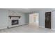 Cozy living room featuring a stone fireplace and an open floor plan at 5345 Pilgrim Point Rd, Cumming, GA 30041