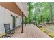 Side porch with wooden ceiling and view of landscaped yard at 5345 Pilgrim Point Rd, Cumming, GA 30041