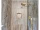 A stylish shower features gold hardware, decorative tile, and a handheld sprayer at 5345 Pilgrim Point Rd, Cumming, GA 30041