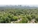 Aerial view of neighborhood with lush greenery; Atlanta skyline in background at 1748 N Pelham Ne Rd, Atlanta, GA 30324