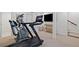 Finished basement features modern exercise equipment and a neutral color palette for a functional space at 1748 N Pelham Ne Rd, Atlanta, GA 30324