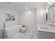 Bright bathroom features a soaking tub, double vanity, and elegant marble herringbone floors at 1748 N Pelham Ne Rd, Atlanta, GA 30324