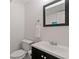 Simple, clean bathroom features a vanity with a dark cabinet and a white toilet at 1748 N Pelham Ne Rd, Atlanta, GA 30324