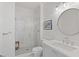 Bright bathroom featuring tiled shower, toilet, and single sink with a light blue cabinet at 1748 N Pelham Ne Rd, Atlanta, GA 30324