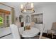 Bright dining room with elegant lighting, stylish furniture, and access to other rooms at 1748 N Pelham Ne Rd, Atlanta, GA 30324