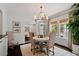 Elegant dining room featuring a round table, chandelier, and views of the backyard at 1748 N Pelham Ne Rd, Atlanta, GA 30324