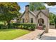 Charming home featuring a stone chimney, brick walkway, and well-manicured landscaping at 1748 N Pelham Ne Rd, Atlanta, GA 30324