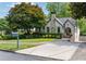 Quaint home with a stone chimney, neat landscaping, and driveway at 1748 N Pelham Ne Rd, Atlanta, GA 30324