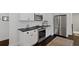 Stylish kitchen with stainless steel appliances, white cabinets, and dark countertops at 1748 N Pelham Ne Rd, Atlanta, GA 30324
