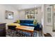 Cozy living room with a blue sofa, bright pillows, and a wooden coffee table on a patterned rug at 1748 N Pelham Ne Rd, Atlanta, GA 30324
