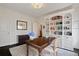 Home office featuring custom built-in shelving, hardwood floors, and neutral paint at 1748 N Pelham Ne Rd, Atlanta, GA 30324