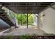 Covered stone patio with stairs to backyard, offering an outdoor living space at 1748 N Pelham Ne Rd, Atlanta, GA 30324
