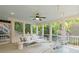 Inviting screened patio with comfortable seating and hanging chair, perfect for relaxation and enjoying nature at 1748 N Pelham Ne Rd, Atlanta, GA 30324