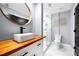Stylish bathroom featuring wood countertop, vessel sink, statement mirror and a sleek, glass-enclosed shower at 1924 Variations Ne Dr, Atlanta, GA 30329