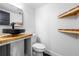 Chic powder room features a vessel sink, floating wood shelves, and modern fixtures at 1924 Variations Ne Dr, Atlanta, GA 30329