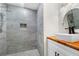 Updated bathroom with a vessel sink, wood countertop, modern fixtures, and tiled walk-in shower at 1924 Variations Ne Dr, Atlanta, GA 30329