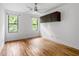 Bedroom features gleaming hardwood floors, ceiling fan, and windows that provide plenty of natural light at 1924 Variations Ne Dr, Atlanta, GA 30329