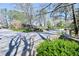 Neighborhood entrance with beautiful trees, mature landscaping, and ample parking at 1924 Variations Ne Dr, Atlanta, GA 30329