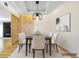Staged dining room features a modern chandelier, table setting and decorative wood panel at 1924 Variations Ne Dr, Atlanta, GA 30329