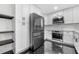 A kitchen showcases stainless steel appliances, white cabinets, and black tile floors at 1924 Variations Ne Dr, Atlanta, GA 30329