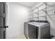 Well-equipped laundry room featuring a modern washer and dryer, plus wire shelving for organization at 1924 Variations Ne Dr, Atlanta, GA 30329
