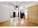 Bright living room featuring hardwood floors, decorative wood panel, and open floor plan at 1924 Variations Ne Dr, Atlanta, GA 30329