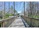 Inviting wooden bridge leads to the community pool surrounded by lush trees at 1924 Variations Ne Dr, Atlanta, GA 30329