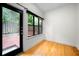 Bright sunroom with hardwood floors and large windows offering views of the outdoor deck and landscaping at 1924 Variations Ne Dr, Atlanta, GA 30329