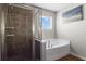 Bathroom features a shower and separate tub, with tiled walls and a window at 237 Parc Drive Dr, Canton, GA 30114