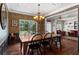 Dining room area featuring hardwood floors, a large window, wainscoting and a view of the living room at 237 Parc Drive Dr, Canton, GA 30114