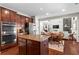 Spacious kitchen with stainless steel appliances, granite counters, and an island open to the living room at 237 Parc Drive Dr, Canton, GA 30114