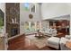 Open-concept living room with a stone fireplace, hardwood floors, and views of the backyard at 237 Parc Drive Dr, Canton, GA 30114
