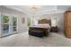 Spacious main bedroom featuring a tray ceiling, french doors, carpet flooring, and a tranquil atmosphere at 237 Parc Drive Dr, Canton, GA 30114