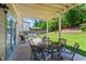 Relaxing covered patio features a dining table and comfortable seating area at 237 Parc Drive Dr, Canton, GA 30114