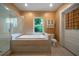 Bright bathroom featuring a soaking tub with tile surround and a separate glass-enclosed shower at 1276 Lanier Ne Blvd, Atlanta, GA 30306