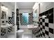 Black and white tiled bathroom featuring a tub/shower and two pedestal sinks at 1276 Lanier Ne Blvd, Atlanta, GA 30306