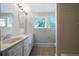 This bright bathroom offers a double sink vanity and a separate shower, plus natural light from the windows at 1276 Lanier Ne Blvd, Atlanta, GA 30306